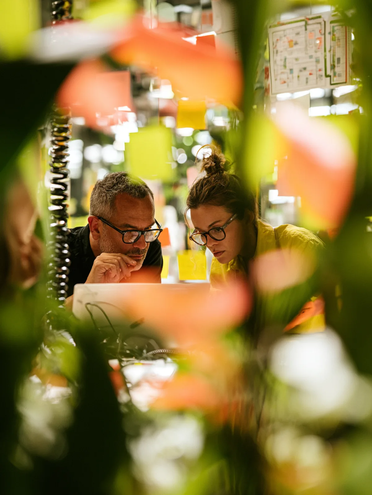 Two Jurashift engineers reviewing code together on one laptop in the Wimbledon studio